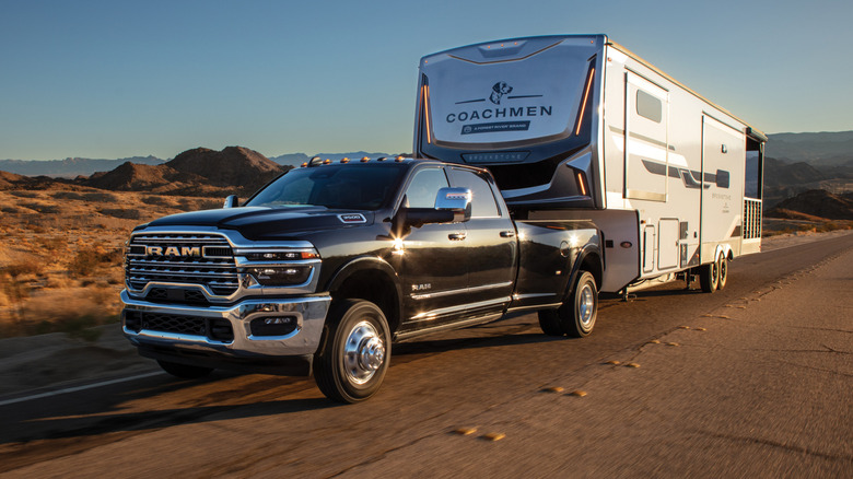 Black 2025 Ram 3500 Limited dually pulling a recreational vehicle