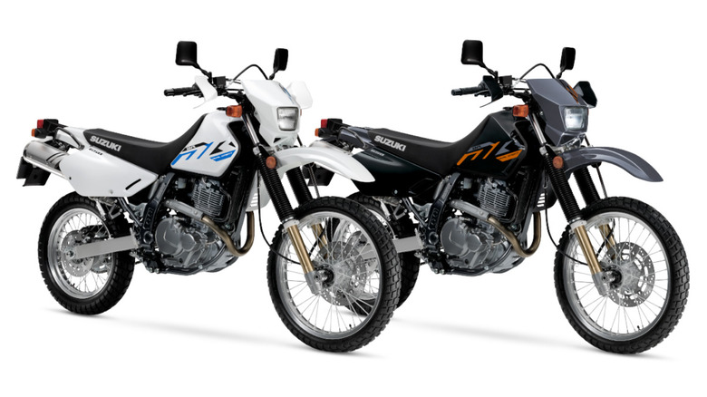 Two Suzuki DR650S motorcycles on a white background
