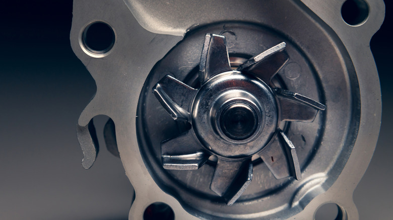 Close up view of a brand new water pump amidst a contrasting white and black background