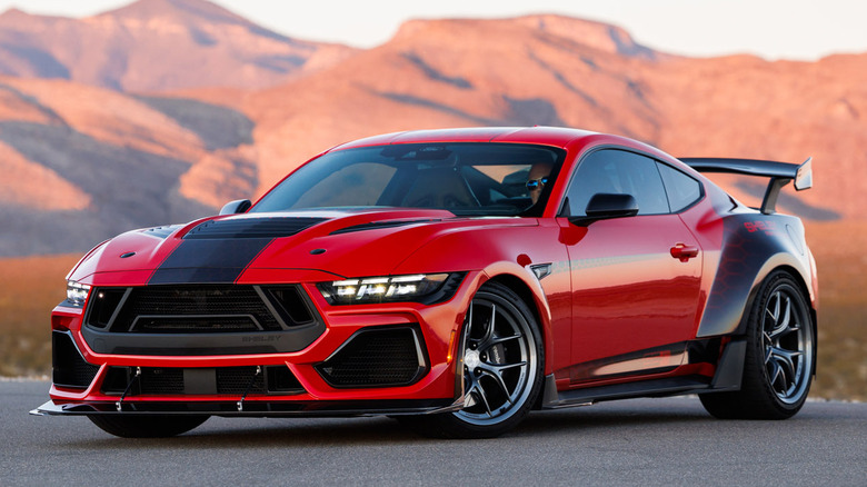 A Red and black 2026 Shelby Super Snake-R parked on a track with mountains in background