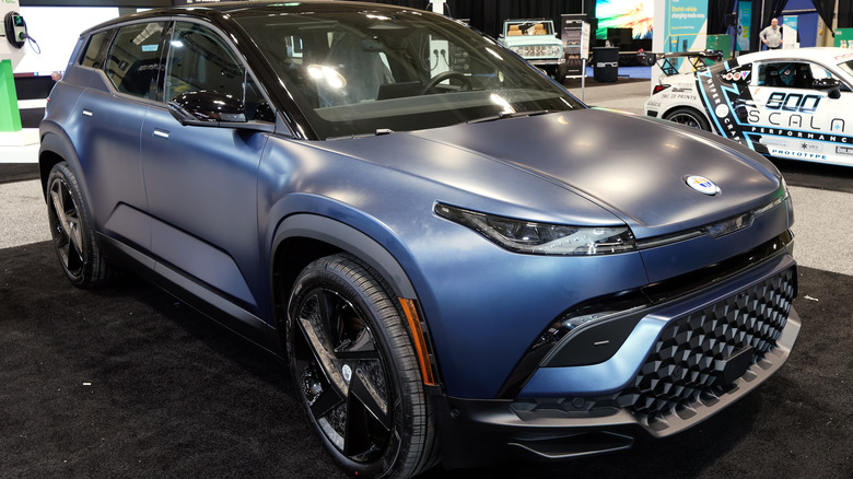 A Fisker Ocean is parked inside on display.