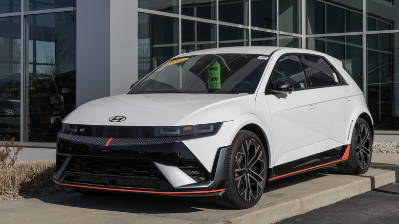 A white Hyundai Ioniq 5 sits outside a dealership.