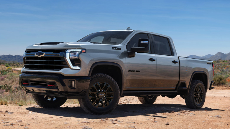 A gray 2026 Chevrolet Silverado HD parked on dirt in the sun