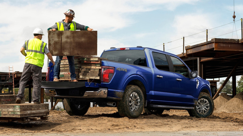 Construction crew working with the help of a blue 2026 Ford F-150