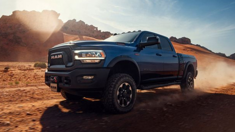 A blue Ram HD driving offroad