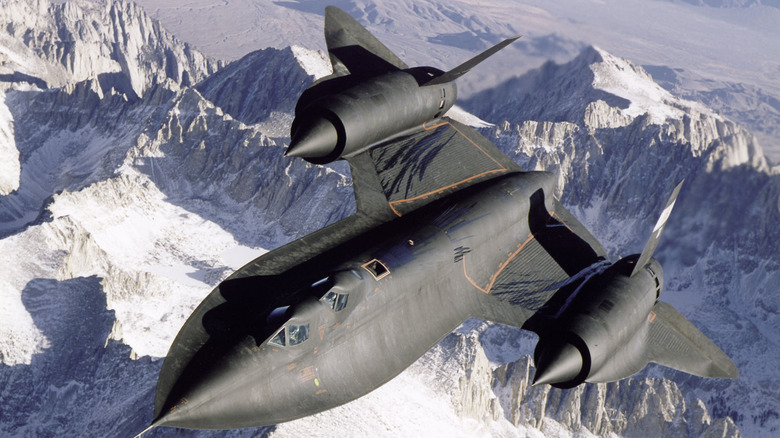 SR-71 photographed over snow-capped mountains.