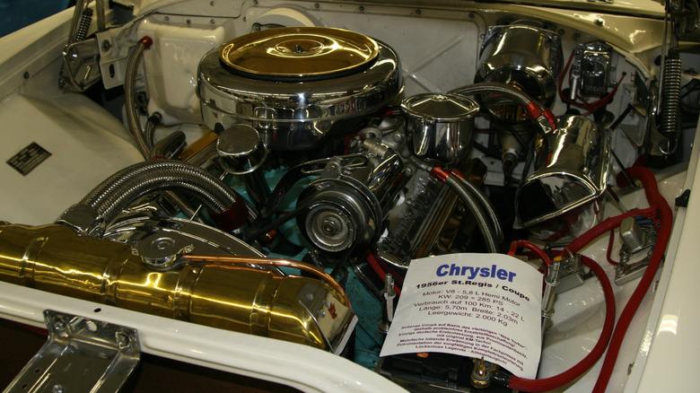 A 1956 Chrysler FirePower hemi engine inside a St.Regis Coupe, on display at a car show.