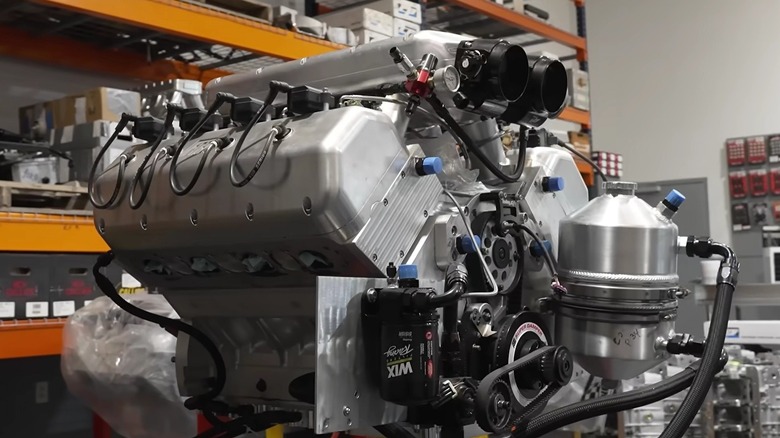 For Hemis Only iconi 909 ci hemi engine on display in a garage.