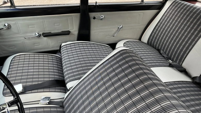 A photo of the black and white striped interior of a Rambler Classic 550 sedan with the front seat folded back to form a bed