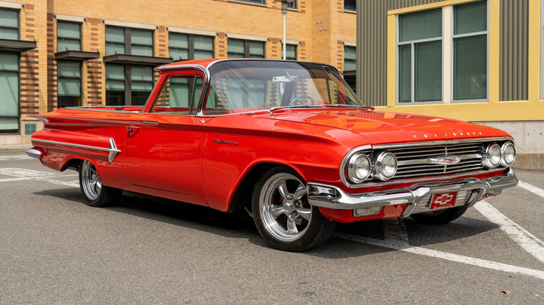 front three-quarters shot of a red 1960 El Camino parked in front of a building