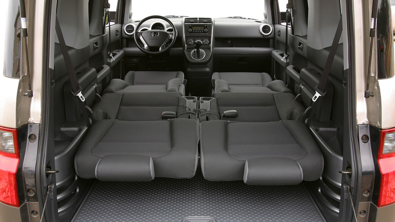 A look through the open tailgate of a Honda Element with both rows of seats folded flat like a bed