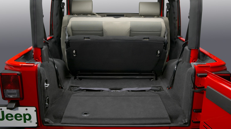 A look at the cargo area in a red JK Jeep Wrangler two-door with is second row flipped forward