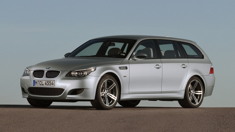 Front 3/4 view of a silver BMW M5 Touring