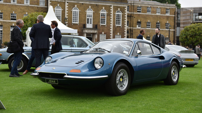 A blue Ferrari 246 GTS at a car show