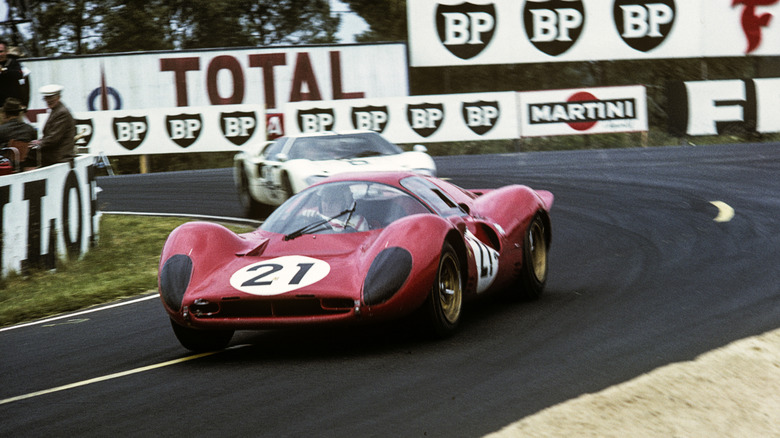 A red Ferrari 330 P4 racing at Le Mans