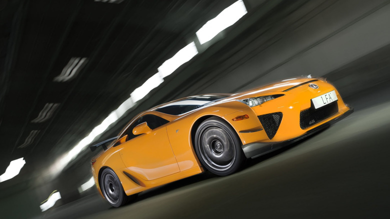 An orange Lexus LFA Nurburgring Package driving through a tunnel