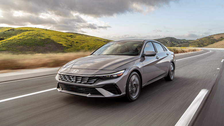 A 2026 Hyundai Elantra painted in grey driving down a road
