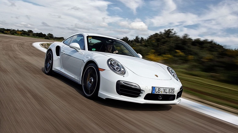 On-track image of a 2014 Porsche 911 Turbo S in white.