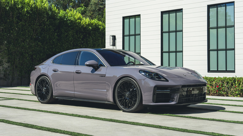Product image of a 2025 Panamera Turbo S E-Hybrid against a suburban background.