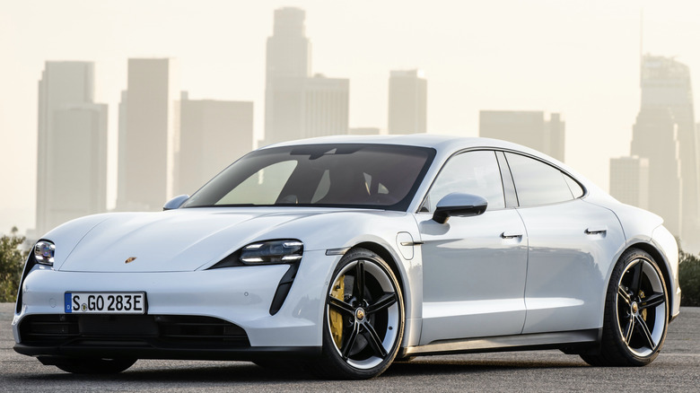 Picture of a white 2020 Taycan Turbo S against city skyline.