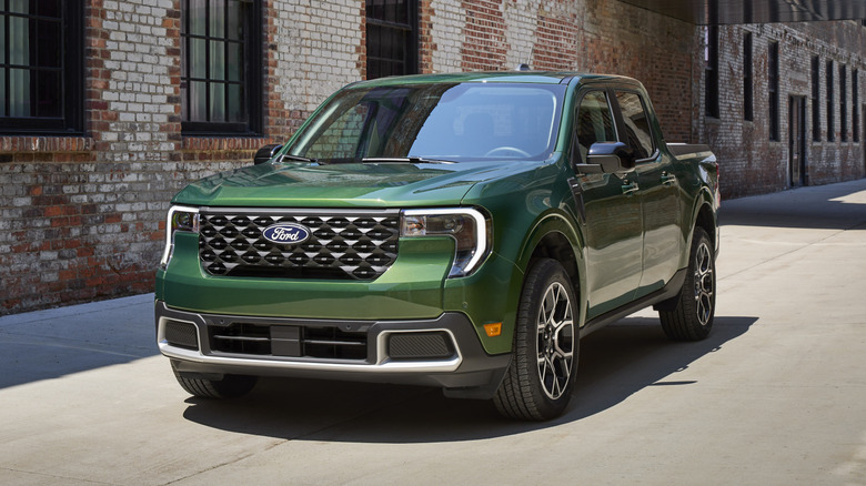 2025 Ford Maverick parked on a paved surface next to a red brick building