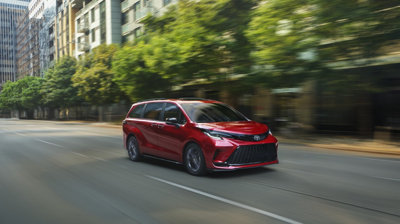 A front 3/4 of a red 2026 Toyota Sienna XSE driving on a street