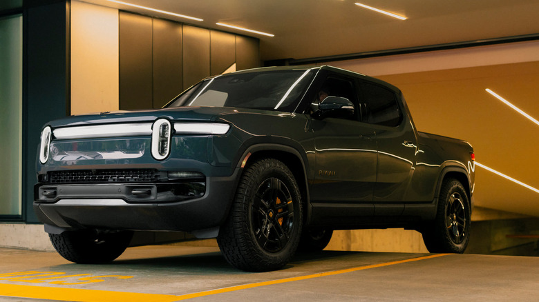 2026 Rivian R1T exits a city parking garage.