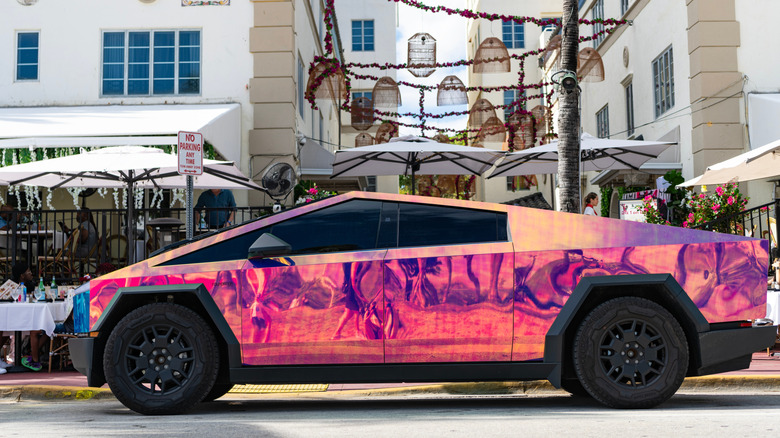 Side view of a pink chrome Tesla Cybertruck