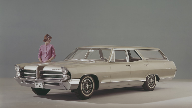 A woman admiring the new Pontiac Bonneville station wagon for 1965. (Photo by Archive Photos/Getty Images)