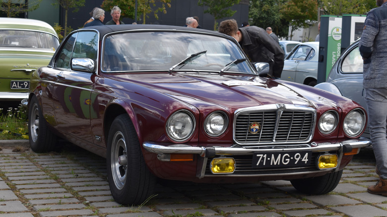 Huizen, the Netherlands - July 6, 2024: a red 1976 Jaguar XJ XJ6 Coupe