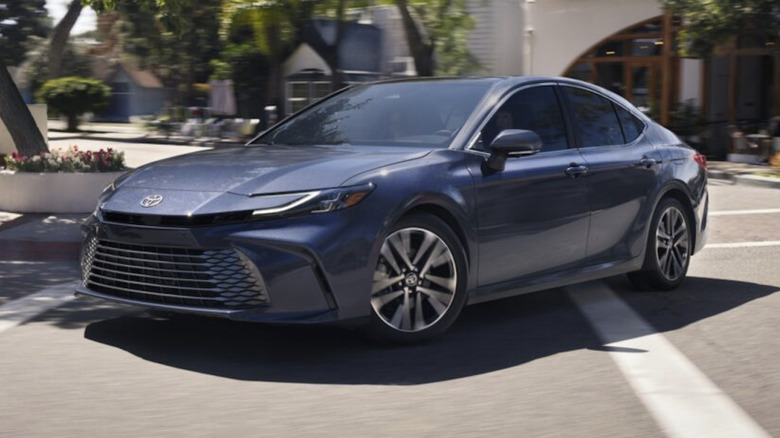 Toyota Camry being driven through a parking lot