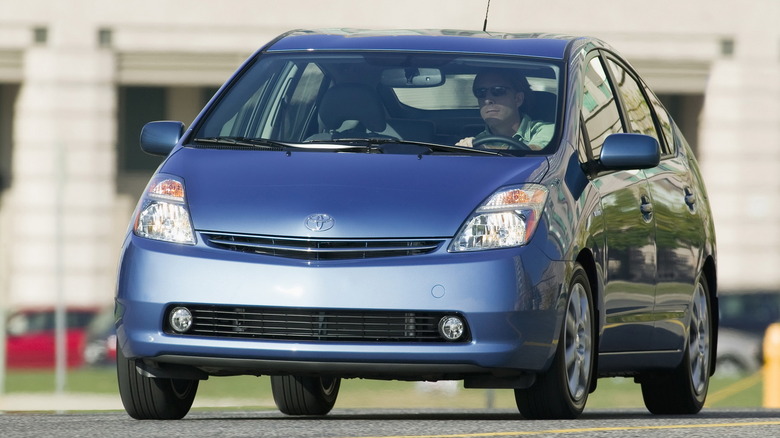 Toyota Prius hatchback being driven in a parking lot