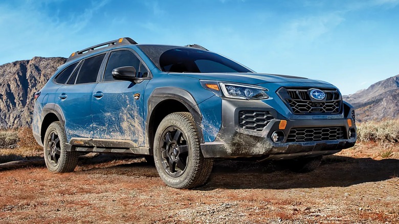 A blue 2025 Subaru Outback parked in the desert