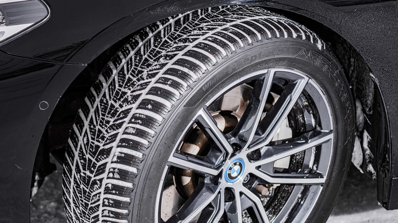 A close up image of a Hankook winter tire mounted on a BMW.