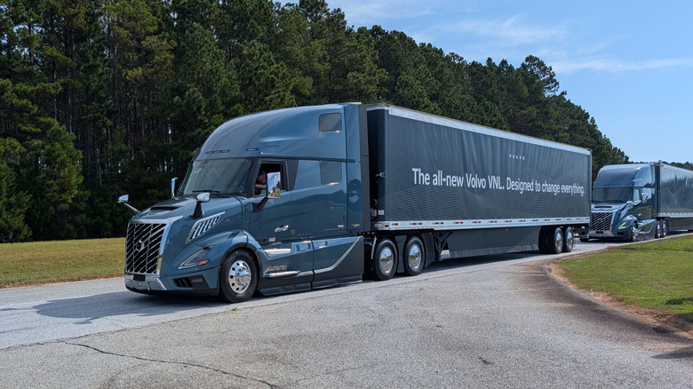 Front 3/4 view of a huge blue Volvo VNL semi truck