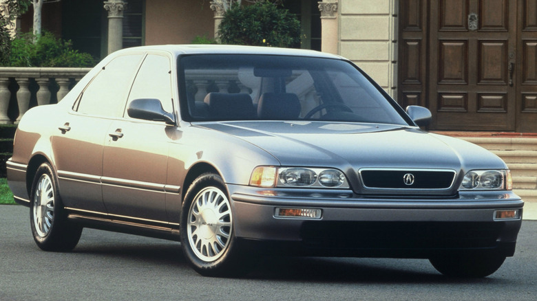 front three quarters view of a silver '95 Legend parked in front of a house