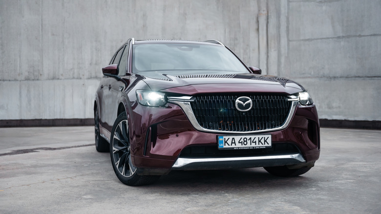 A burgundy Mazda CX-90 sitting parked.