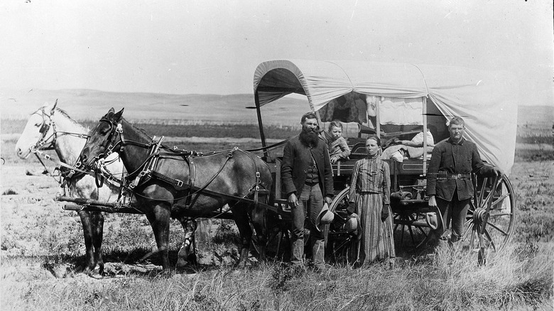 Photograph of a Family with Their Covered Wagon During the Great Western Migration