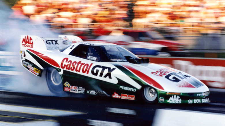 John Force's Castrol GTX-liveried Funny Car takes off down the quarter mile