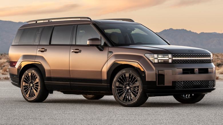 2025 Hyundai Santa Fe Hybrid parked on a paved surface with mountains in the background