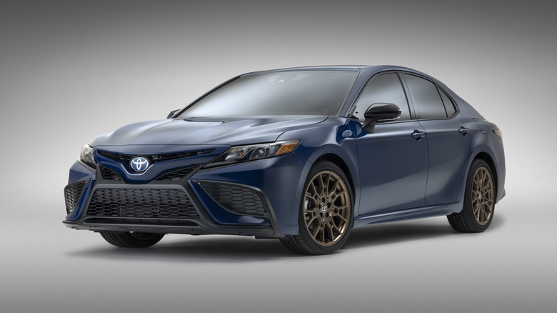 Blue 2024 Toyota Camry sedan front left view seen in a studio