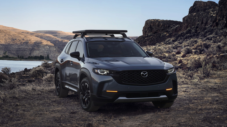 A black 2025 Mazda CX-50 parked in a desert environment.
