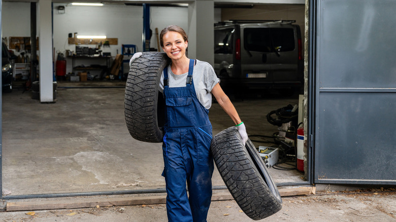 Woman carrying tires astatine section workshop