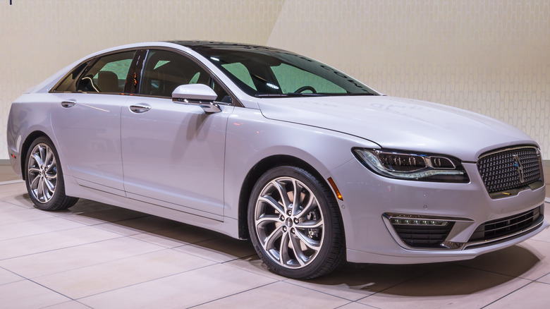 White Lincoln MKZ sedan on display at an auto show