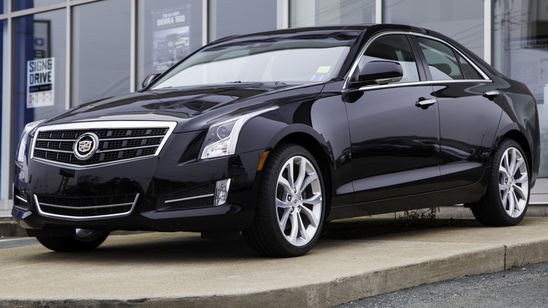 Black Cadillac ATS sedan parked outside of a dealership