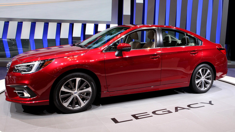 Dark red Subaru Legacy on display at an auto show