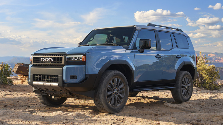 A blue Toyota Land Cruiser parked in the desert