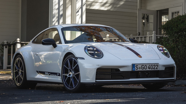 A white Porsche 911 T pictured in a home driveway.