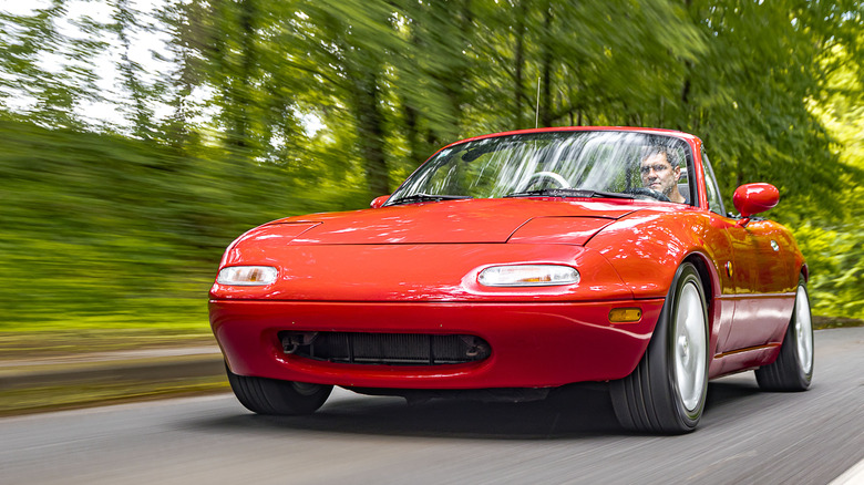 Zagreb, Croatia - May 20, 2019: Man is driving Mazda MX-5 aka Miata fast on the road. This iconic Japanese sports roadster became very popular in the eighties because it was affordable.
