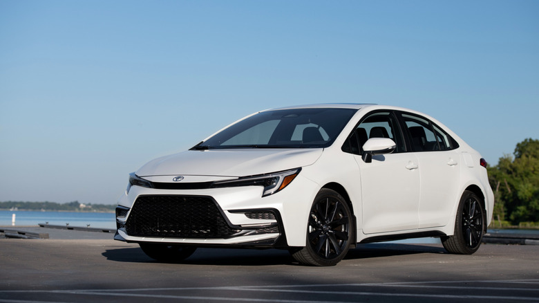 A pearl white 2026 Toyota Corolla on a paved pier.